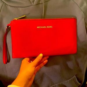 Hot Pink Michael Kors clutch/wristlet with gold lettering in great condition